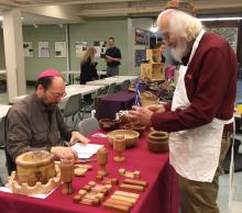 Roy Luft, craftsman, talks to potential customer, Howard Feinstein